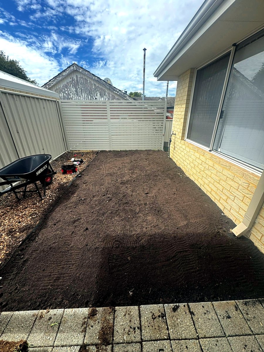 Yard before turf installation, bare prepared soil